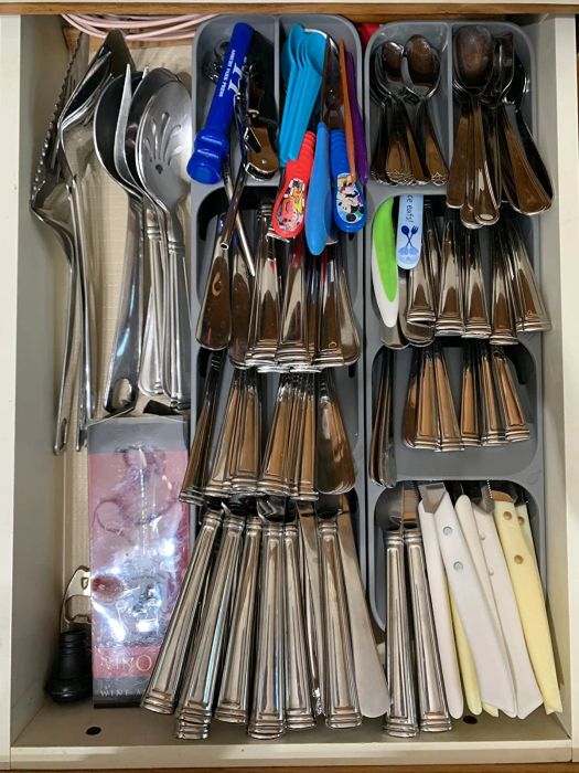 reviewer photo showing two organizers inside a drawer, neatly storing various utensils