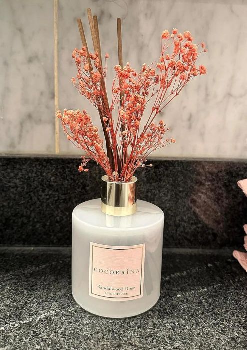 Reviewer's diffuser with orange blossoms placed on a marble surface