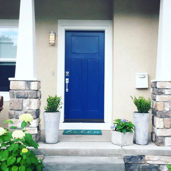 A reviewer showcases their front door painted in a striking blue color.