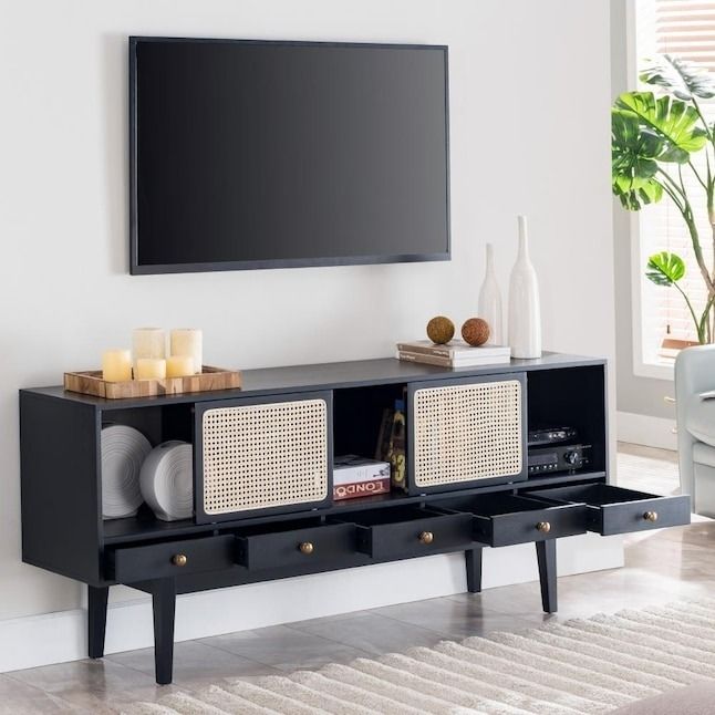 A modern black media console with decorative items arranged inside
