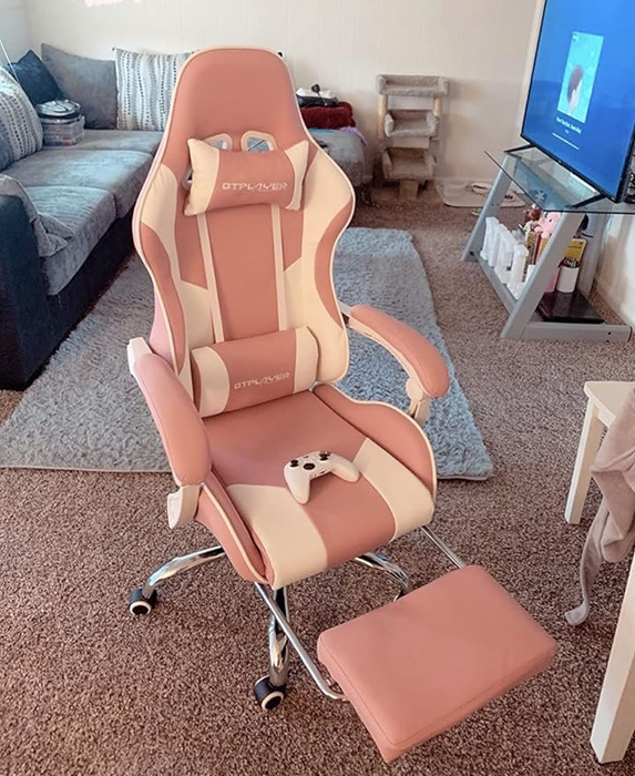 A reviewer demonstrates the pink chair with its reclining feature.