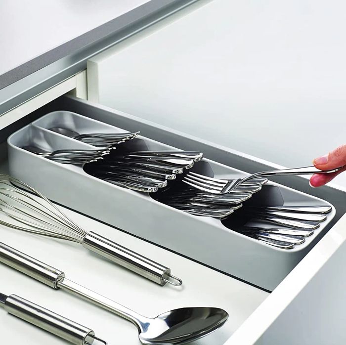 the neatly stacked utensil organizer inside a drawer 