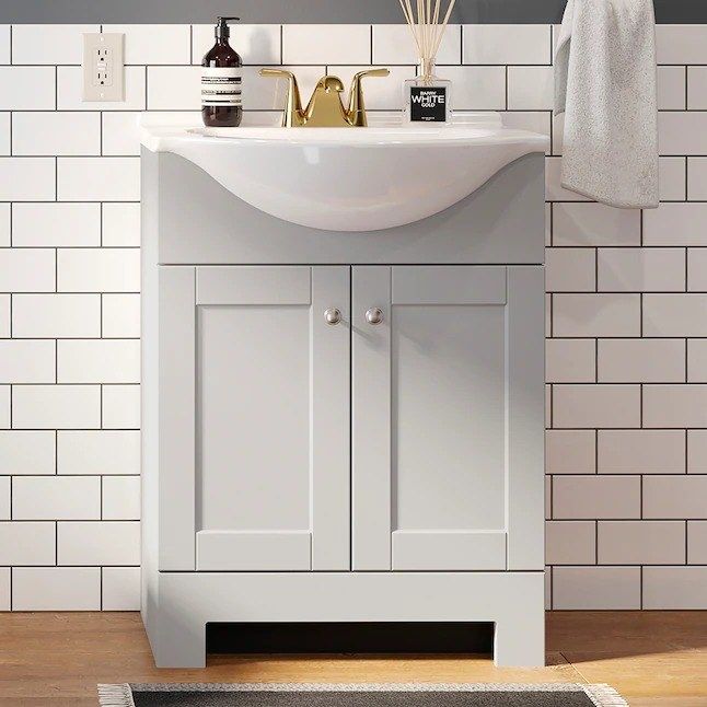 the gray vanity featuring a gold faucet