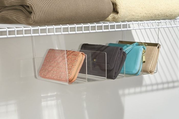 A clear shelf with dividers to neatly store wallets.