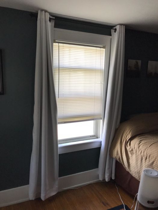 The same room with the Nicetown blackout curtains drawn back, allowing the sunlight to stream in.