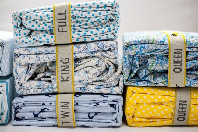 Stacks of sheets with yellow and off-white bands wrapped around them, keeping everything neatly organized.