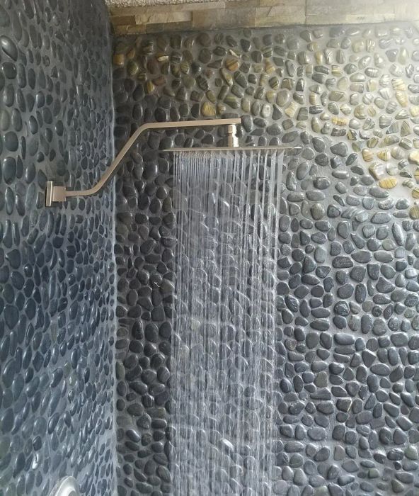 A slim spout with a flat water head, cascading a wide sheet of water down.