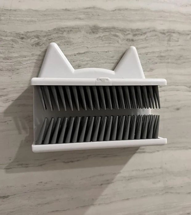 A photo of a reviewer holding the hair catcher