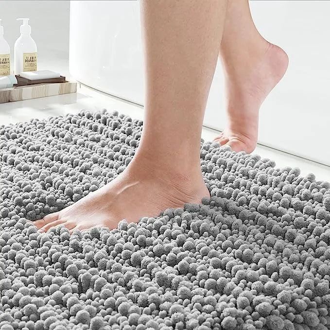A model stepping onto the luxurious, soft surface of the chenille bath rug
