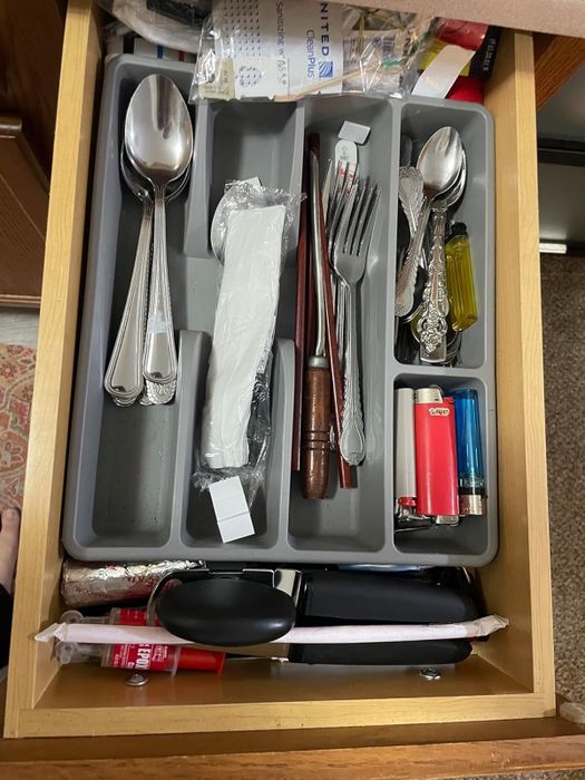 Reviewer’s before image of an overcrowded silverware drawer