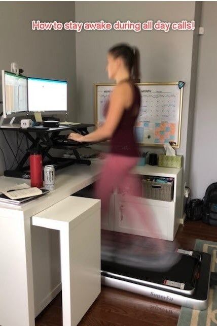 A reviewer using the treadmill at their desk with a caption that reads.