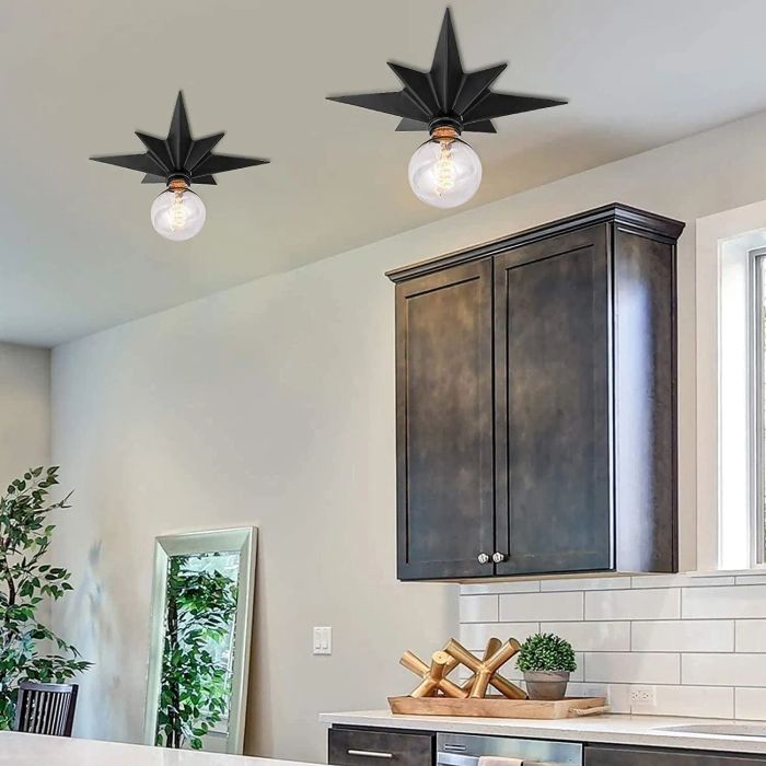 Two identical lights on the ceiling of a kitchen.