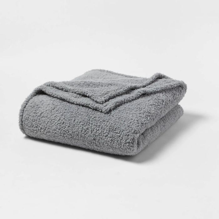 A neatly folded soft-textured gray blanket, perfect for adding warmth or enhancing your home decor.