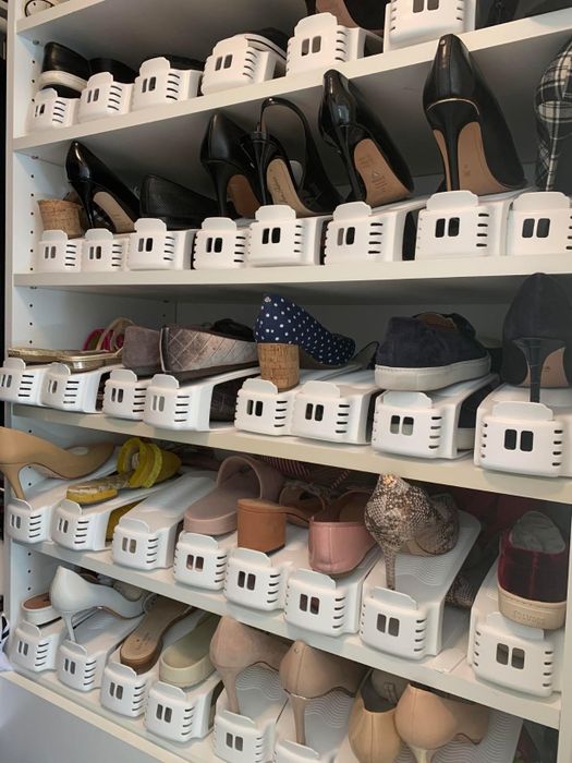 Several shelves in the reviewer’s closet filled with shoes neatly arranged using Shoe Slotz