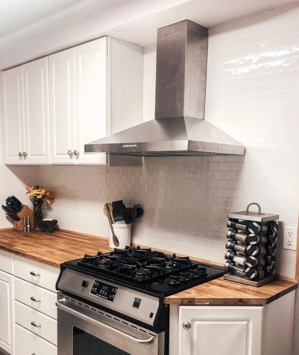 A reviewer's kitchen featuring peel-and-stick subway tile wallpaper on the walls.