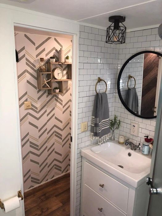 A reviewer's RV camper bathroom with subway tiles behind the sink vanity.