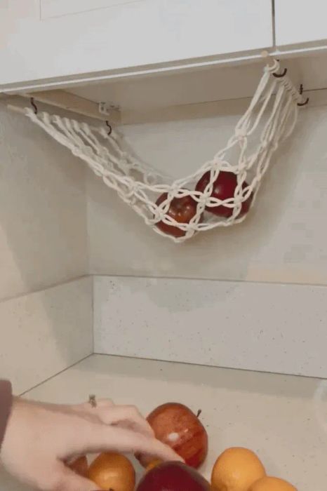 A gif showing a model placing apples and oranges into the hanging basket