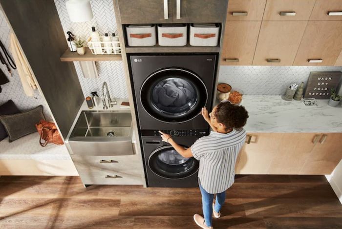 A woman adjusting the main controls on the dryer