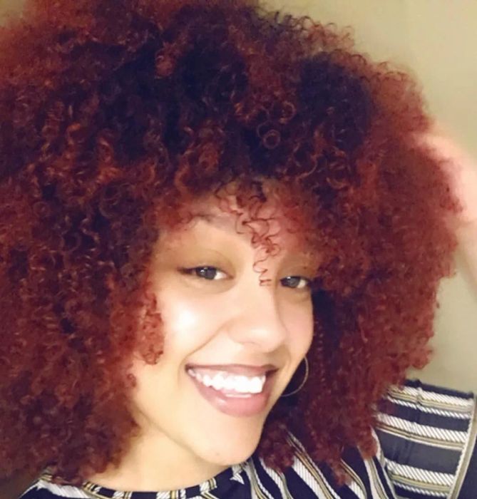 A reviewer with defined, coily hair