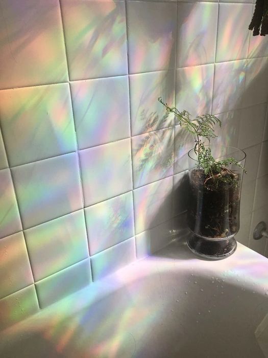 A different reviewer captures the mesmerizing rainbow effect on the wall from the stained-glass decals.