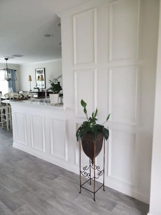 A reviewer's wall, now enhanced with panels installed and painted white, creating added depth and visual interest.