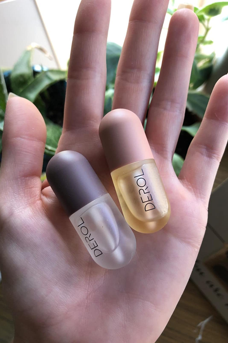 A reviewer holding a set of lip plumpers