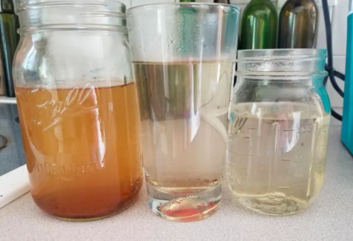 A customer review showing a photo of the dirty water that came out of their Keurig after using the cleaning cup