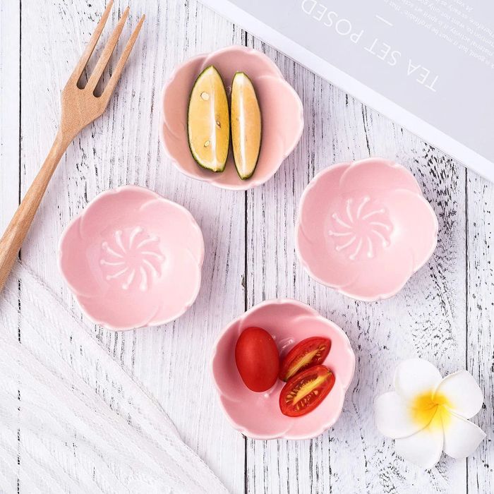 Four pink cherry blossom dishes neatly arranged