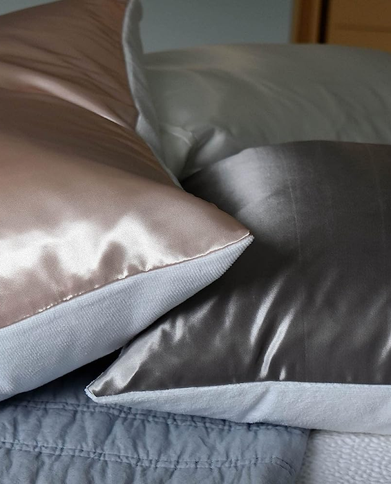 A side view of the pink and gray satin pillows.
