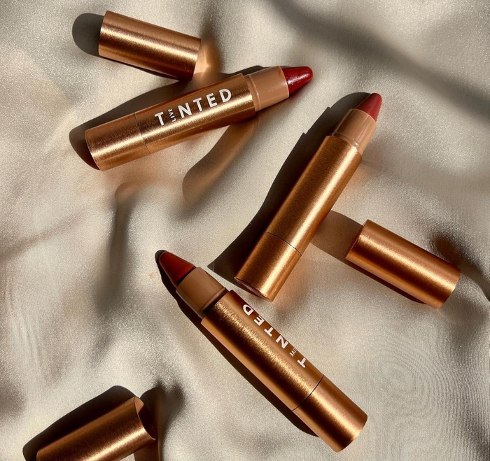 A trio of metallic lipstick tubes, each labeled with its shade