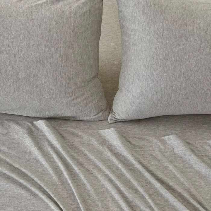 Two pillows and a bed with soft, crumpled bedding fabric, symbolizing comfort and quality, perfect for a shopping-related feature.