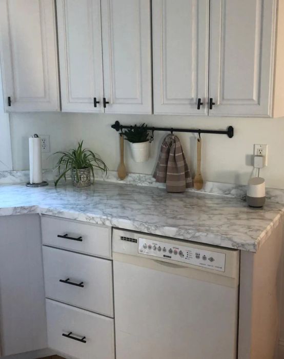 An after shot of the same countertop now beautifully covered with faux marble contact paper