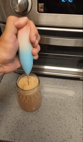 A gif of another reviewer using the frother in their coffee