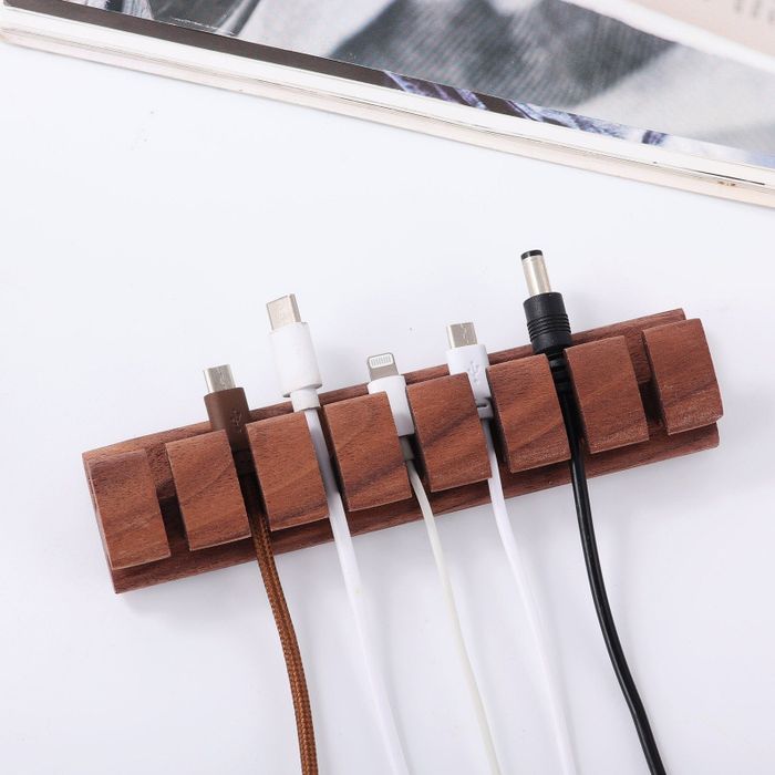 The dark wood organizer neatly storing cords