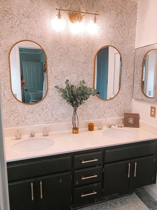 Another reviewer's bathroom featuring black cabinets with elegant gold pulls installed on the drawers and cabinets for a chic update.