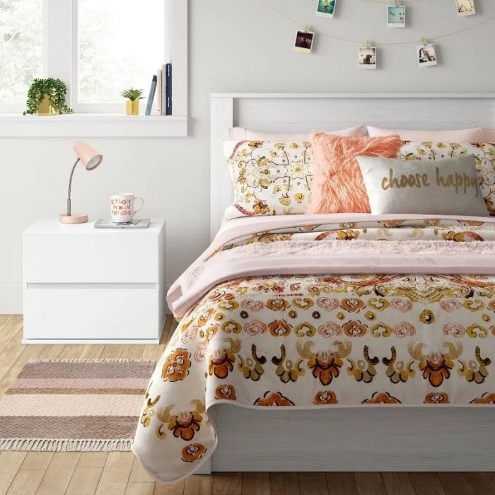 A white nightstand placed in a bedroom