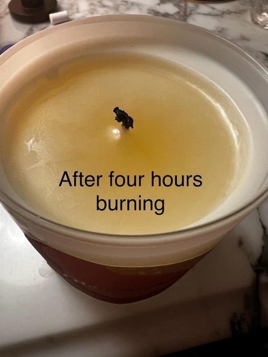 After four hours of burning, the candle shows an even wax surface with text indicating its burn time. Perfect for articles under the Shopping category.