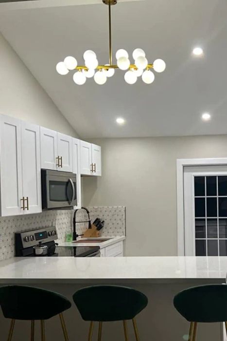 A reviewer showcases their chandelier above the kitchen island, enhancing the space.