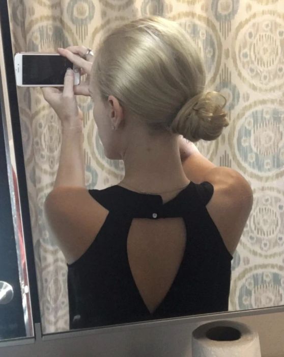 Reviewer styling their hair into a chic bun