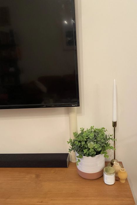 A close-up view of a Mytourer's TV showcasing the beige cord cover.