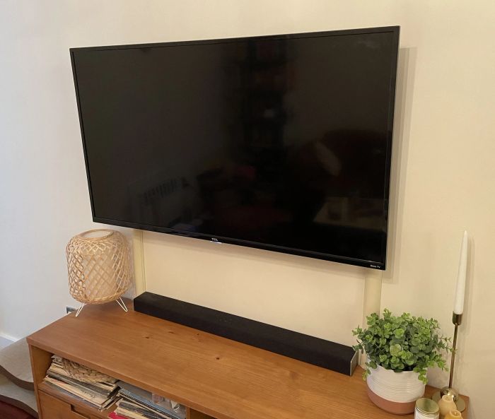 A Mytourer's TV with a beige cord cover in place.