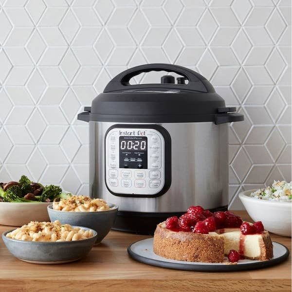 The Instant Pot surrounded by various delicious foods, each served on separate plates, showcasing the versatility of this kitchen gadget.