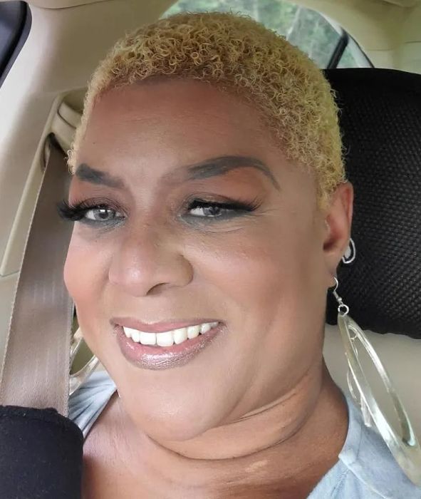 A reviewer showcasing flawless foundation application using the brush.