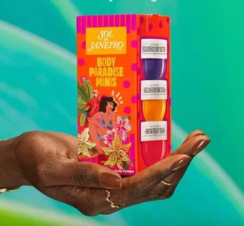 A hand holding Sol de Janeiro Body Paradise Minis, featuring three body creams with vibrant tropical packaging.