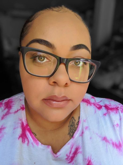 A reviewer selfie showing smooth, pore-free skin