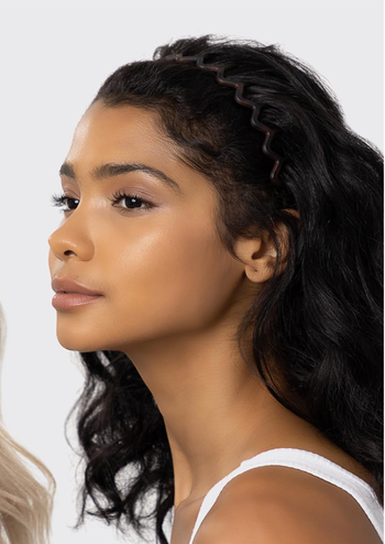 A model sporting a wavy headband in their hair