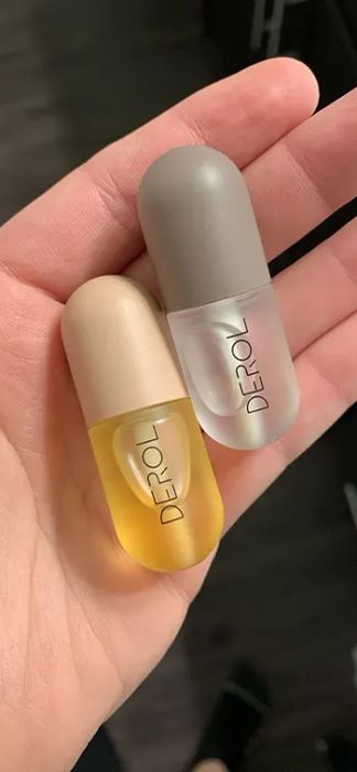 reviewer holding lip plumping glosses