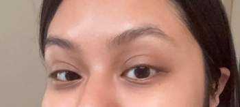 A close-up of a person’s face featuring natural eye makeup and smooth skin, perfect for a beauty or skincare shopping article.