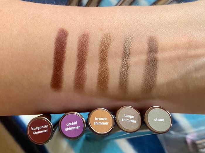 Arm displaying swatches of five different eyeliner shades