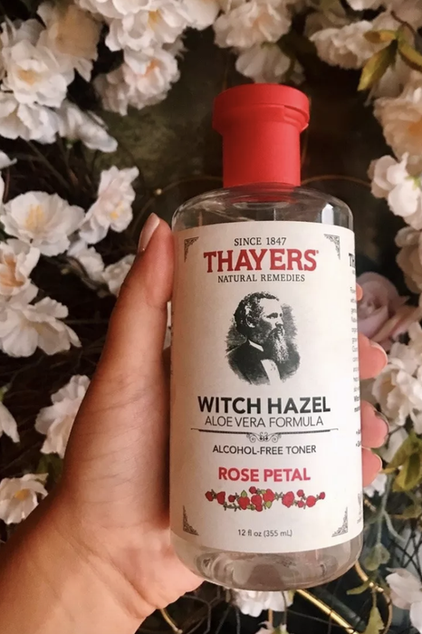 AnaMaria holding a bottle of Thayers Witch Hazel toner.